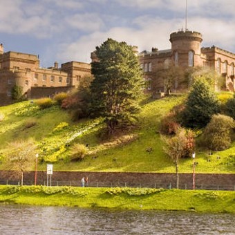 a castle on top of a grass covered field